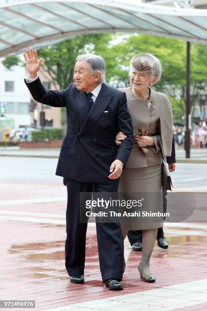 Emperor Akihito and Empress Michiko wave to well-wishers on arrival at JR Fukushima Station after their visit to Fukushima on June 11, 2018 in...