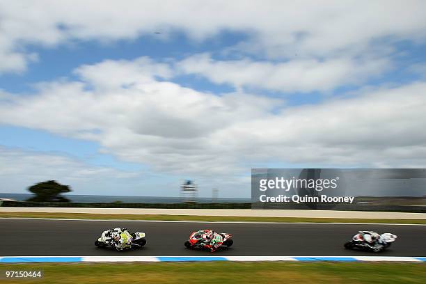 Jonathan Rea of Great Britain and the Hannspree Ten Kate Honda Team and Max Biaggi of Italy and the Aprilia Alitalia Racing Team rounds the bend...