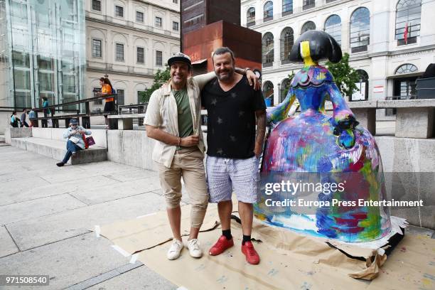 The artist Domingo Zapata poses with an street musician after restoring his artwork, the menina 'La vida es sueno', in front of Queen Sofia Museum on...