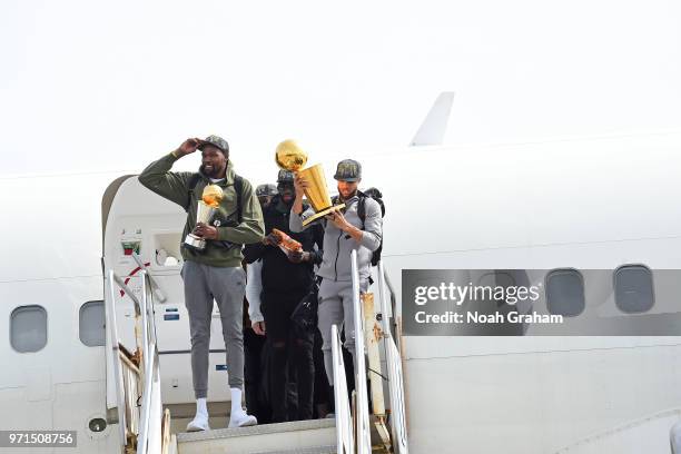 Kevin Durant and Stephen Curry of the Golden State Warriors exit the plane with the Larry O'Brien Championship Trophy and the Bill Russell Finals MVP...