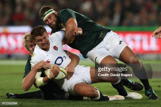 Henry Slade of England is tackled by Thomas du Toit and Pieter-Steph du Toit during the first test match between South Africa and England at Elllis...