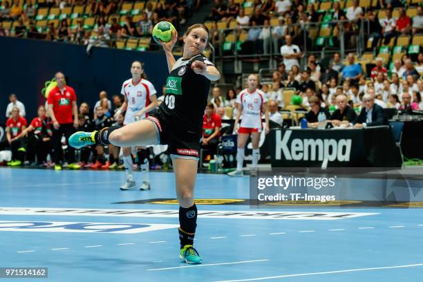 Anna Loerper of Germany throws the ball during the Women's handball International friendly match between Germany and Poland at Olympiahalle on June...