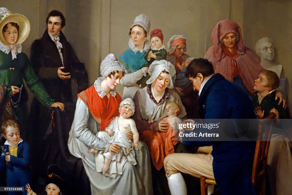 Doctor vaccinating babies with cowpox to protect them from the more virulent infection smallpox.