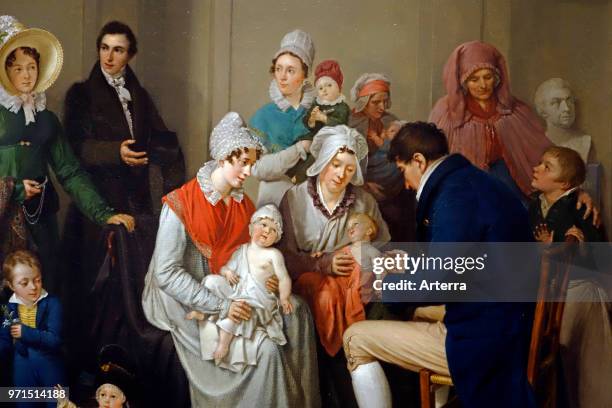 Nineteenth century painting showing doctor vaccinating babies with cowpox to protect them from the more virulent infection smallpox.