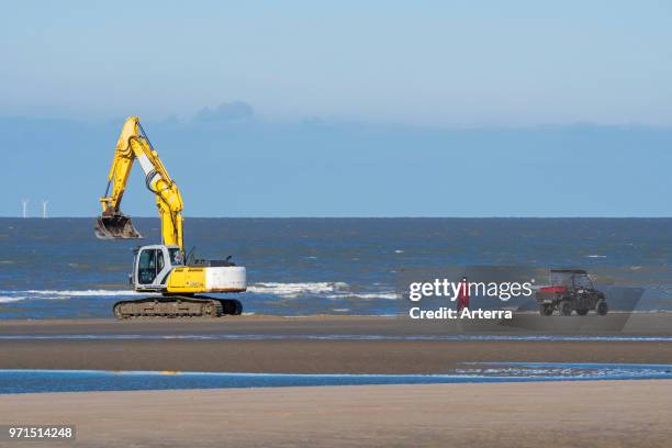 Search & Recovery team searching for German WWII mines and unexploded ordnance on beach between Wenduine and De Haan, West Flanders, Belgium.