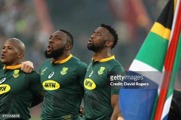Siya Kolisi, the first non white South Africa Springbok captain sings the national anthem with team mates Tendai Mtawarira and Bongi Mbonambi during...