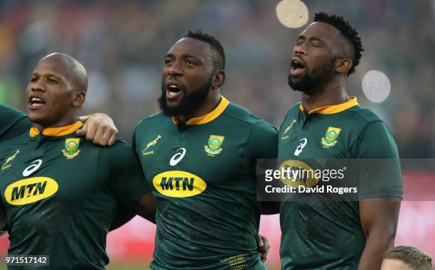 Siya Kolisi, the first non white South Africa Springbok captain sings the national anthem with team mates Tendai Mtawarira and Bongi Mbonambi during...
