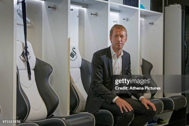 Graham Potter sits on one of the seats in the changing room during the unveiling of the new manager Graham Potter at The Fairwood Training Ground on...