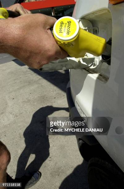 Une personne remplit son réservoir de gasoil, le 25 août 2000 dans une station d'essence à Honfleur. Le ministre de l'Agriculture, Jean Glavany,...