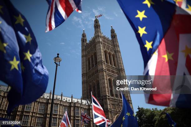 And Union Jack flags are waved as anti-Brexit demonstrators gather outside the Houses of Parliament on June 11, 2018 in London, England. The EU...