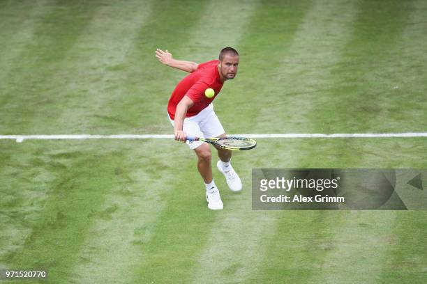 Mikhail Youzhny of Russia plays a backhand to Mischa Zverev of Germany during day 1 of the Mercedes Cup at Tennisclub Weissenhof on June 11, 2018 in...