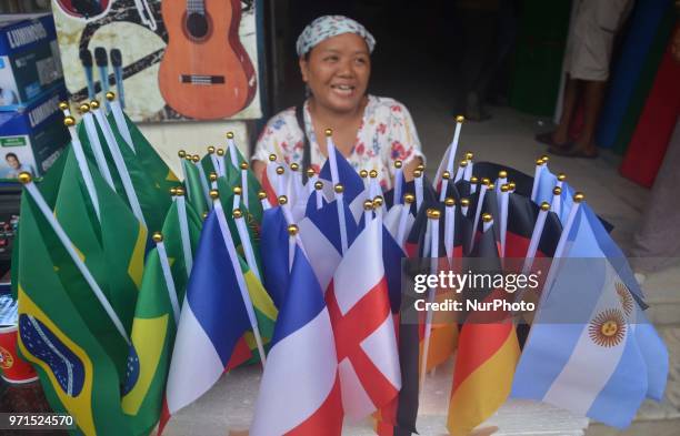 Woman sales flag of different countries on street ahead of the FIFA World Cup 2018 in Dimapur, India north eastern state of Nagaland on Monday June...