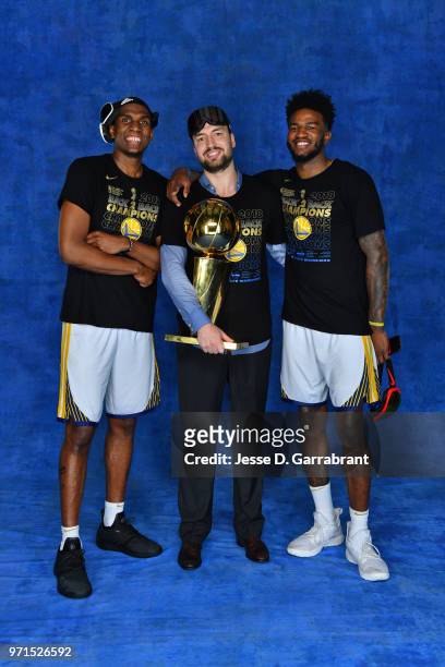 Chris DeMarco, Jordan Bell and Kevon Looney of the Golden State Warriors pose for a portrait with the Larry O'Brien Trophy after winning Game Four of...