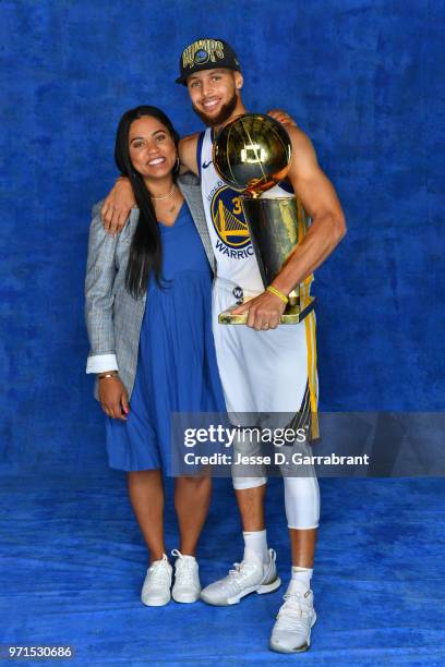 Stephen Curry of the Golden State Warriors poses for a portrait with his wife, Ayesha Curry and Larry O'Brien Trophy after winning Game Four of the...