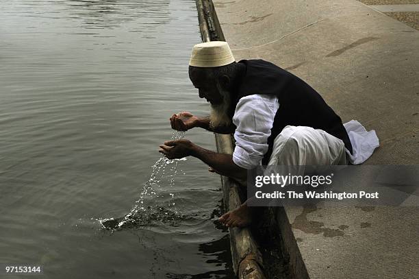 Mostafa Kamal originally from Noakhali, Bangladesh, performs an ablution known as "wudu" in the reflecting pond in front of the capitol, before the...