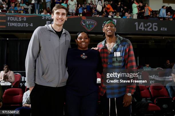 Luke Kornet, Kym Hampton and Troy Williams pose for a photo during the game between the Indiana Fever and the New York Liberty on June 10, 2018 at...