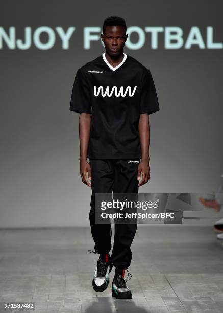 Model walks the runway at the What We Wear show during London Fashion Week Men's June 2018 at the BFC Show Space on June 11, 2018 in London, England.