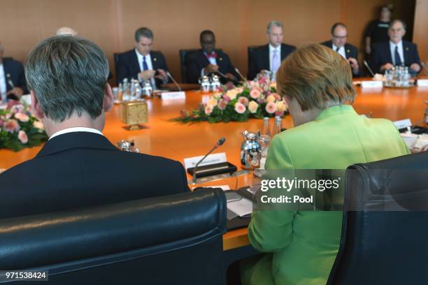 German Chancellor Angela Merkel attends a meeting with the chairmen of international economic and financial organizations including Jim Yong Kim ,...