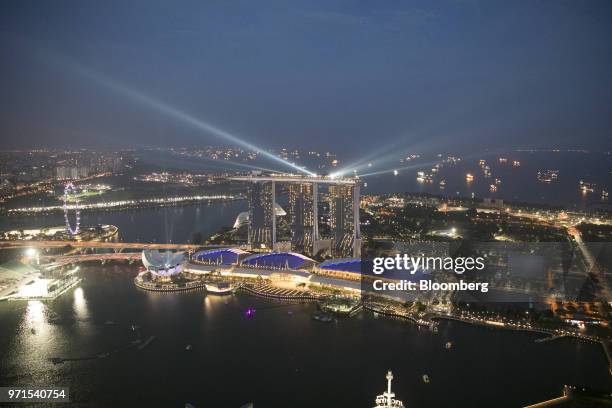 Lights shine from the top of the Marina Bay Sands Hotel at night in Singapore on Monday, June 11, 2018. President Donald Trump is about to see...