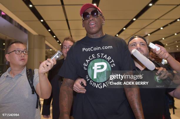 Retired American professional basketball player Dennis Rodman speaks to the press as he arrives at Changi International airport ahead of US-North...