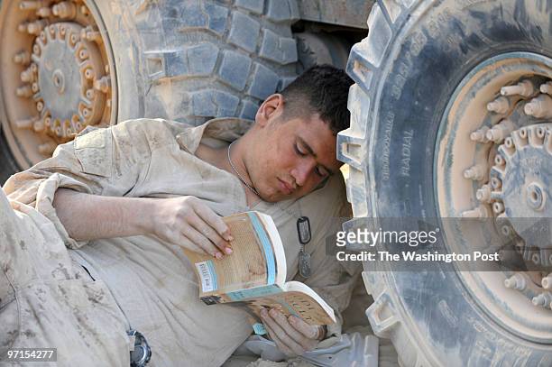 South Afghanistan U.S. Marine Codey Herrera of Draper, Utah, finds a comfortable perch to catch up on a few pages of his book, "The Pact,P by Jodi...