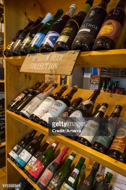 Assortment of beer bottles of Belgian and international beers on display in pub in Flanders, Belgium.