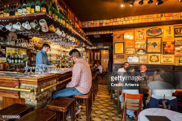 Customers drinking Belgian beer in Flemish cafe 't Brugs Beertje in Bruges / Brugge, West Flanders, Belgium.