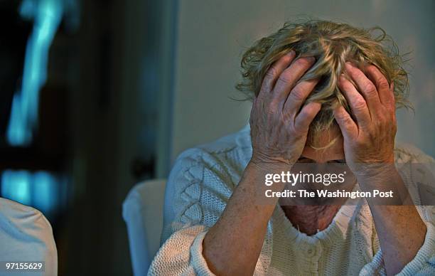 May 27, 2009 PLACE: Woodbridge, VA PHOTOGRAPHER: jahi chikwendiu/twp Gail Ertel holds her head in her hands as she stress over the circumstances of...