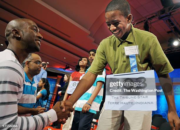 The Scripps National Spelling Bee. Pictured, Kennyi Aouad, right, of Terre Haute, Indiana, gets a supportive handshake from his older brother,...