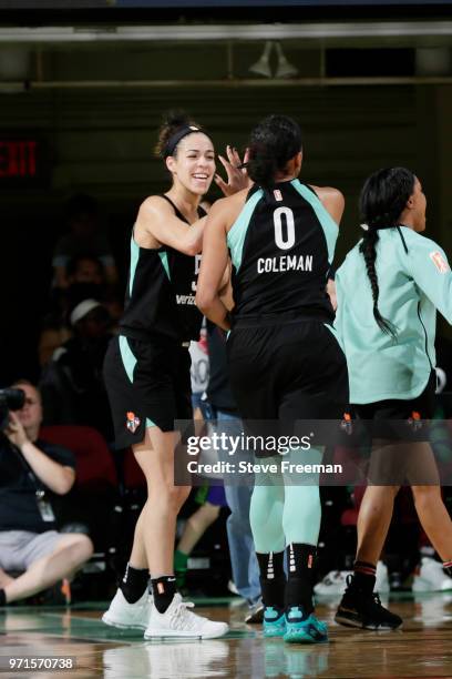 Kia Nurse exchanges high fives with teammate Marissa Coleman of the New York Liberty during the game against the Indiana Fever on June 10, 2018 at...