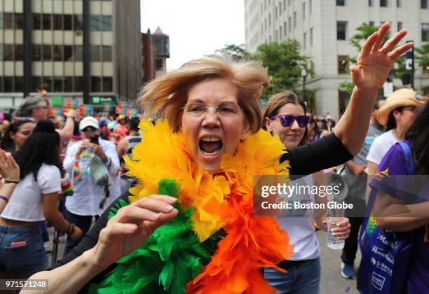 Senator Elizabeth Warren runs down Clarendon Street waving to the crowds during the annual Boston Pride Parade, which took place through the streets...