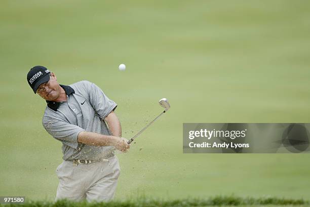 John Cook hits out of the sand on the fourth hole during the third round of the Advil Western Open July 6, 2002 at Cog Hill Golf and Country Club in...