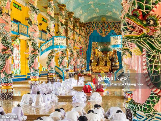 the cao dai faithful in cao dai holy see temple at morning prayer - cao dai temple stock pictures, royalty-free photos & images