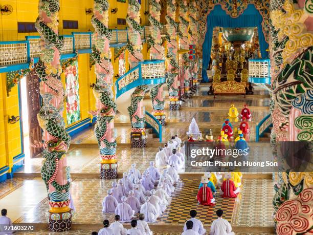 the cao dai faithful in cao dai holy see temple at morning prayer - tay ninh province stock pictures, royalty-free photos & images