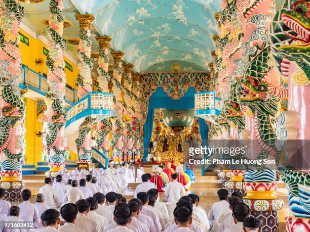 the cao dai faithful in cao dai holy see temple at morning prayer - tay ninh province stock pictures, royalty-free photos & images