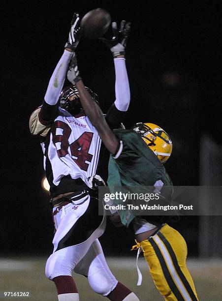 Damascus, MD. HS Football : Paint Branch at Damascus. Here, Paint Branch's Darnell Horton hauls in a pass over Damacus' Brandon Phelps and races for...