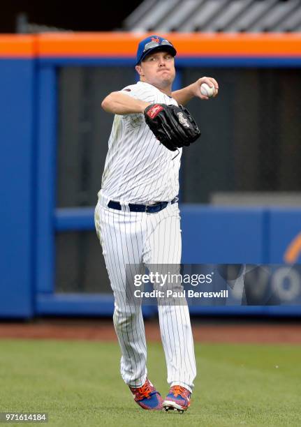 Jay Bruce of the New York Mets makes a running throw after catching the ball in the outfield in an interleague MLB baseball game against the...