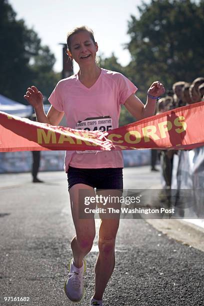 Arlington, VA CREDIT: DOMINIC BRACCO II Cate Fenster of Wooster Ohio crosses the finish line as the first woman to finish the 2008 Marine Corps...