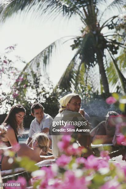 Alice Topping and Minnie Cushing relax with friends in Acapulco, Mexico, February 1966.