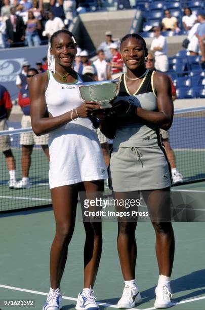 Venus Williams and Serena Williams play tennis at the US Open circa 1999 in New York City.