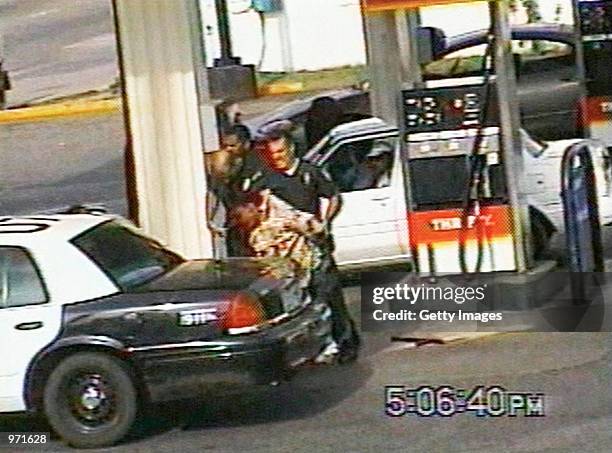 Inglewood police officer Jeremy Morse lifts 16-year-old Donovan Jackson before slamming his body onto the back of a police car on July 8, 2002 in...