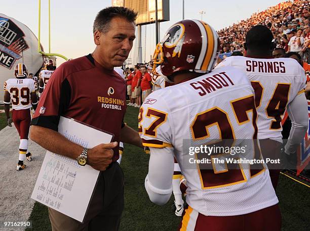 Canton, OH. Indianapolis Colts vs. Washington Redskins. Here, coach Jim Zorn shake cornerback Fred Smoot's hand before pregame introductions.