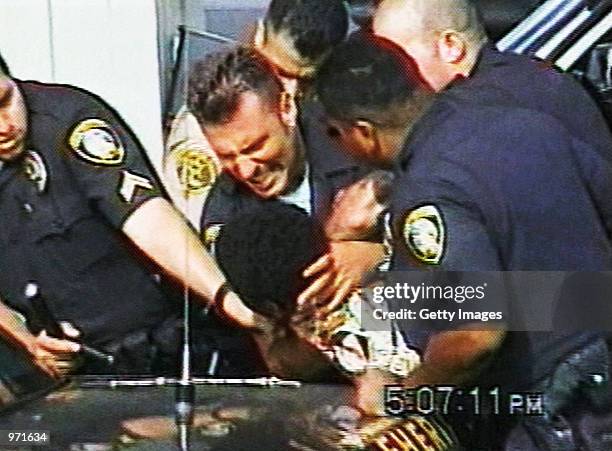 Inglewood police officer Jeremy Morse appears to choke 16-year-old Donovan Jackson on July 8, 2002 in Inglewood, California. Jackson was riding in a...