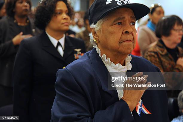 Gladys Schuster Carter stands for the National Anthem during a Black History Month Program Honoring the Legacy of the 6888th Central Postal Directory...