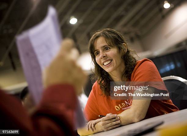 Trisha Bayles of Laurel fills out paper work at a house auction at the Walter E. Washington Convention Center in Washington D.C. On Oct. 4, 2008....