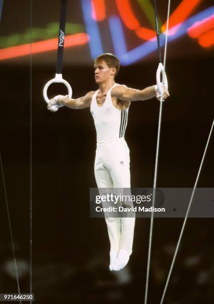 Alexandru Ciuca of Romania performs an Iron Cross on the still rings during the gymnastics competition of the 1990 Goodwill Games held from July 20...