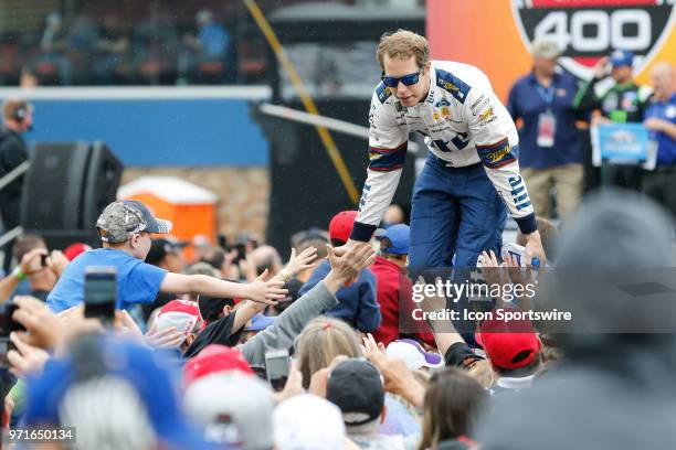 Brad Keselowski , driver of the Miller Lite Ford, greets fans during the pre-race driver introductions prior to the start of the Monster Energy...