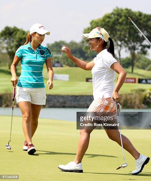 Ai Miyazato of Japan celebrates her victory while Momoko Ueda watches during the final round of the HSBC Women's Champions at the Tanah Merah Country...