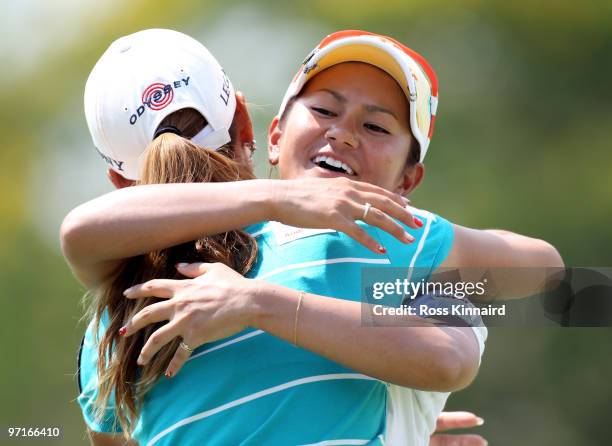 Ai Miyazato of Japan is congratulated by Momoko Ueda of Japan after the final round of the HSBC Women's Champions at the Tanah Merah Country Club on...