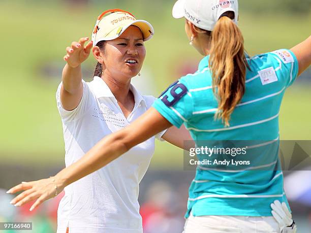 Ai Miyazato of Japan embraces Momoko Ueda of Japan after winning the HSBC Women's Champions at Tanah Merah Country Club on February 28, 2010 in...